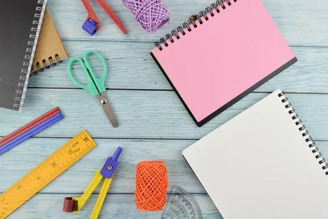 Stationery tools and notebook with copy space over wooden background Stock Photos
