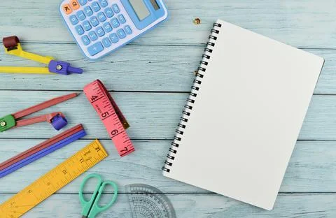 Stationery tools and notebook with copy space over wooden background Stock Photos