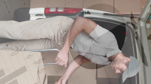 Statistical data processing against caucasian delivery man stacking boxes in his Stock Footage 314122049