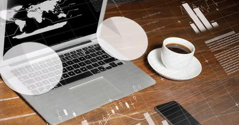 Statistical data processing against laptop and coffee cup on wooden surface 库存照片