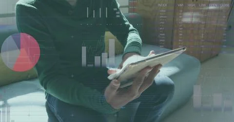Statistical data processing against man using digital tablet at office Foto stock