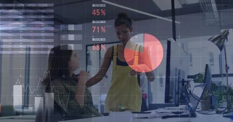 Statistical data processing against two diverse female office colleagues Stock Photos