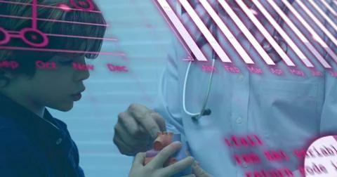 Statistical data processing over asian male doctor showing heart model to Foto stock