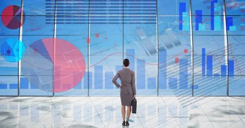 Statistical data processing over businesswoman against blue sky in background 写真素材