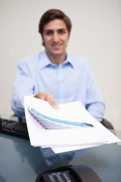 Statistics being handed over by businessman Stock Photos