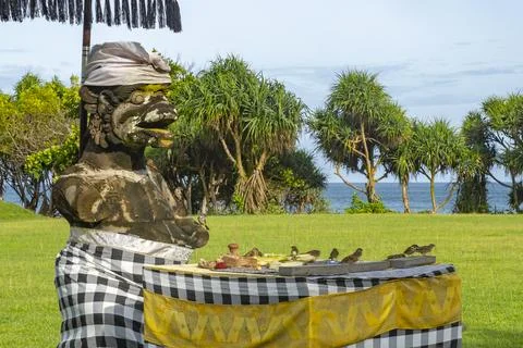 Statue and a table with a checkered tablecloth Stock Photos