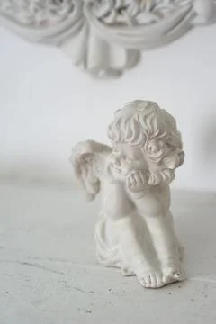 Statue of an angel on a light background in interior Foto stock