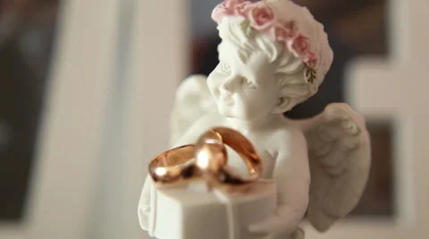 Statue of an angel with wedding rings Stock Footage 53960890
