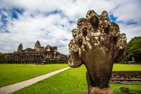 Statue with Angkor Wat in the background Stock Photos