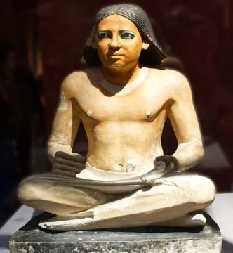 Statue of an anonymous seated Scribe. Stock Photos