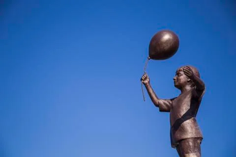 Statue of a boy with a balloon Stock Photos