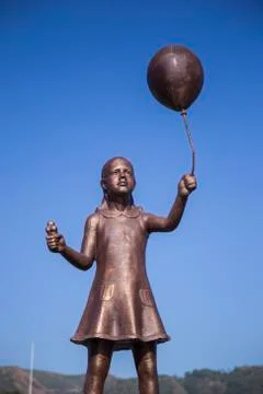 Statue of a boy with a balloon Stock Photos