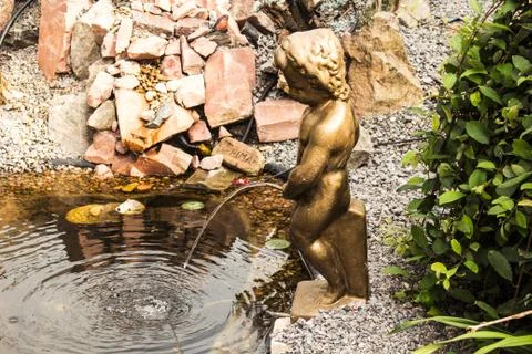 A statue of a boy in the garden Stock Photos