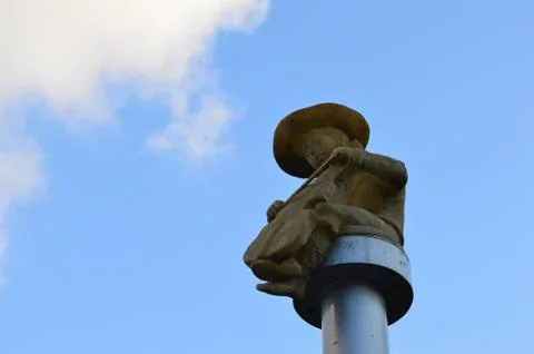 Statue of a boy on a large pillar Stock Photos