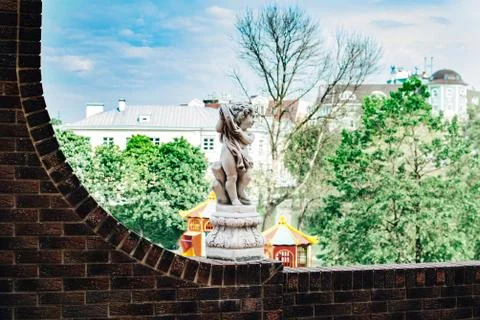 Statue of a boy on a stone wall Stock Photos