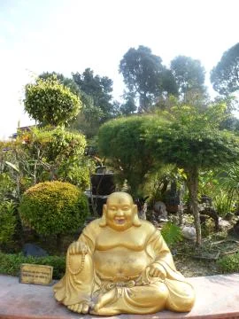 Statue of a bronze smiling monk Stock Photos