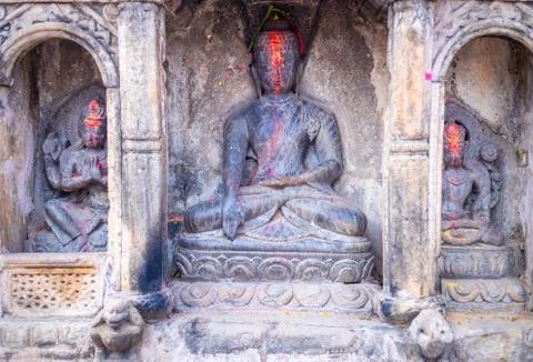 Statue of Budda along side with Hindu Gods and Goddesses carved in a stone. S Stock Photos