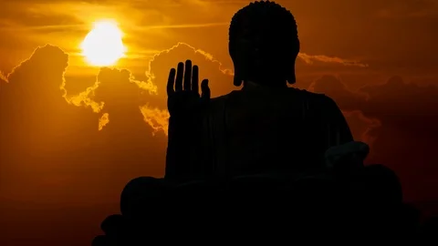 Statue of Buddah at Sunset in Time Lapse with Sun Red Clouds Stock Footage 101677155