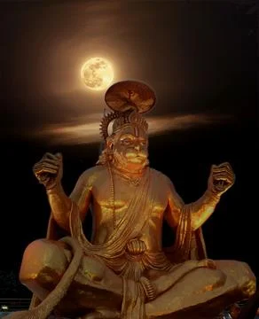 A statue of a buddha sitting on a table next to a full moon Fotos Stock