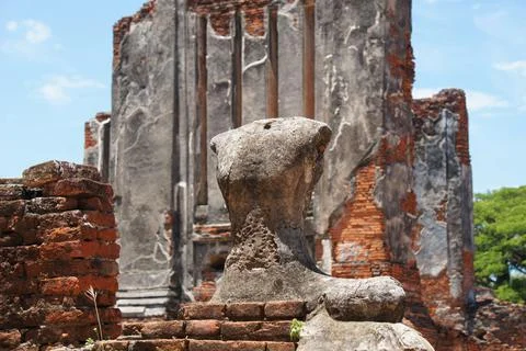 Statue of Buddha Torso in front of wall Stock Photos