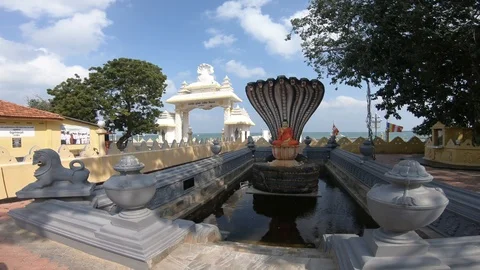 Statue of Buddha under big sevenhead snake Naga among square pond white gates In Stock Footage 111369597