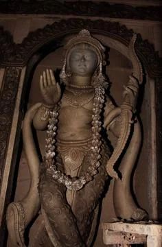 A statue in a building holding a string and two hands 写真素材