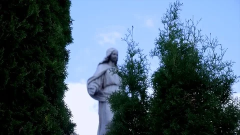 Statue in a cemetery on the sky and trees Stock Footage