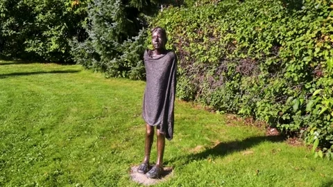 Statue of child freezing after a bath Stock Footage 249896771