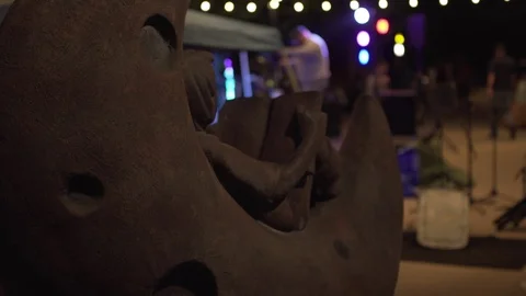 Statue of child ready a book while band sets up for concert in Boulder Colorado Stock Footage 113491827