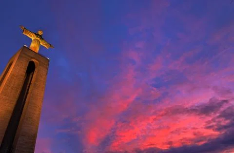 Statue of Christ the King in Lisbon at sunset Stock Photos