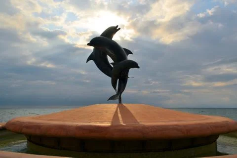 Statue of couple jumping dolphins Stock Photos