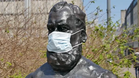 Statue Covered in Face Mask during the Corona Virus Pandemic Stock Footage 152738583
