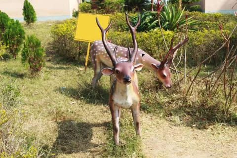 Statue of deer at park Stock Photos