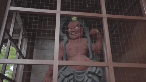 Statue of the devil in japan, standing in a cage. track around the statue Video stock 130202824