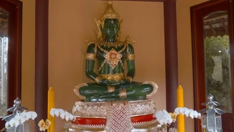 A statue of Emerald or Jade Buddha with golden adornments  스톡 동영상 333452186