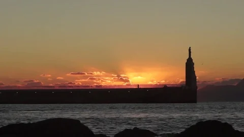 Statue at the end of pier at sunset Stock Footage 77805068