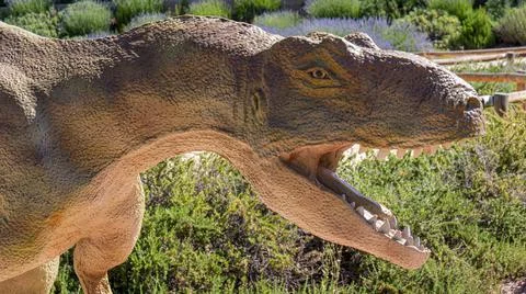 Statue of a ferocious dinosaur in a theme park, Teruel (Spain) Stock Photos