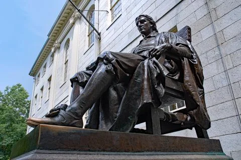 Statue of founder John Harvard on Stock Photos