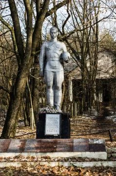A statue in front of an abandoned Stock Photos