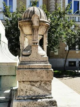 A statue in front of a brick building Stock Photos