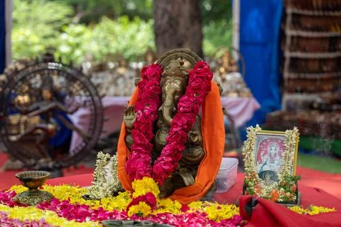 A statue of ganesh is sitting on a table with a red cloth. in Chennai 写真素材