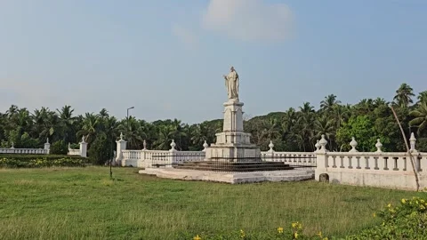 A statue in a grassy, open area surrounded by lush greenery Statue of Jesus.. Stock Footage 296376096