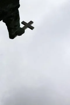 Statue hand holding cross Stock Photos