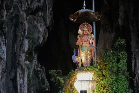 A statue inside Batu Caves, a major Hindu shrine and tourist attraction Stock Photos