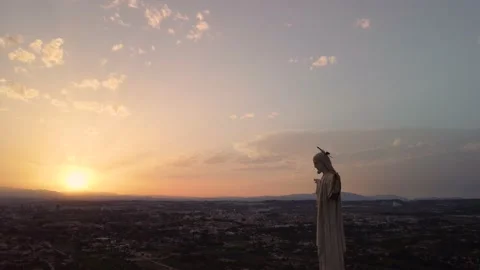 Statue of Jesus looking at the sun at sunset. Cristo de Monteagudo, Murcia, S Stock Footage 222009381