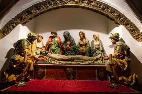 Statue of jesus lying down and people around him, in toledo cathedral Stock Photos