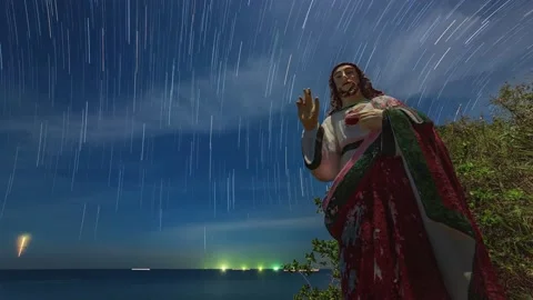 Statue of Jesus on the seashore, clouds and star trails Stock Footage 196805048