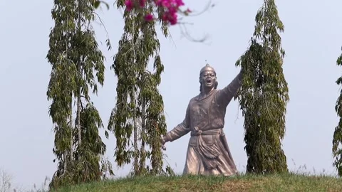 Statue of Lachit Borphukan seen through trees in Dibrugarh Stock Footage 332612906
