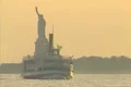 Statue of Liberty and sigtseeing boat at sunset Footage