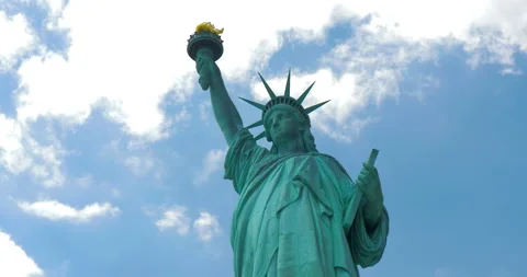 Statue of Liberty on the background of cloudy beautiful sky - facing central Stock Footage 148763194